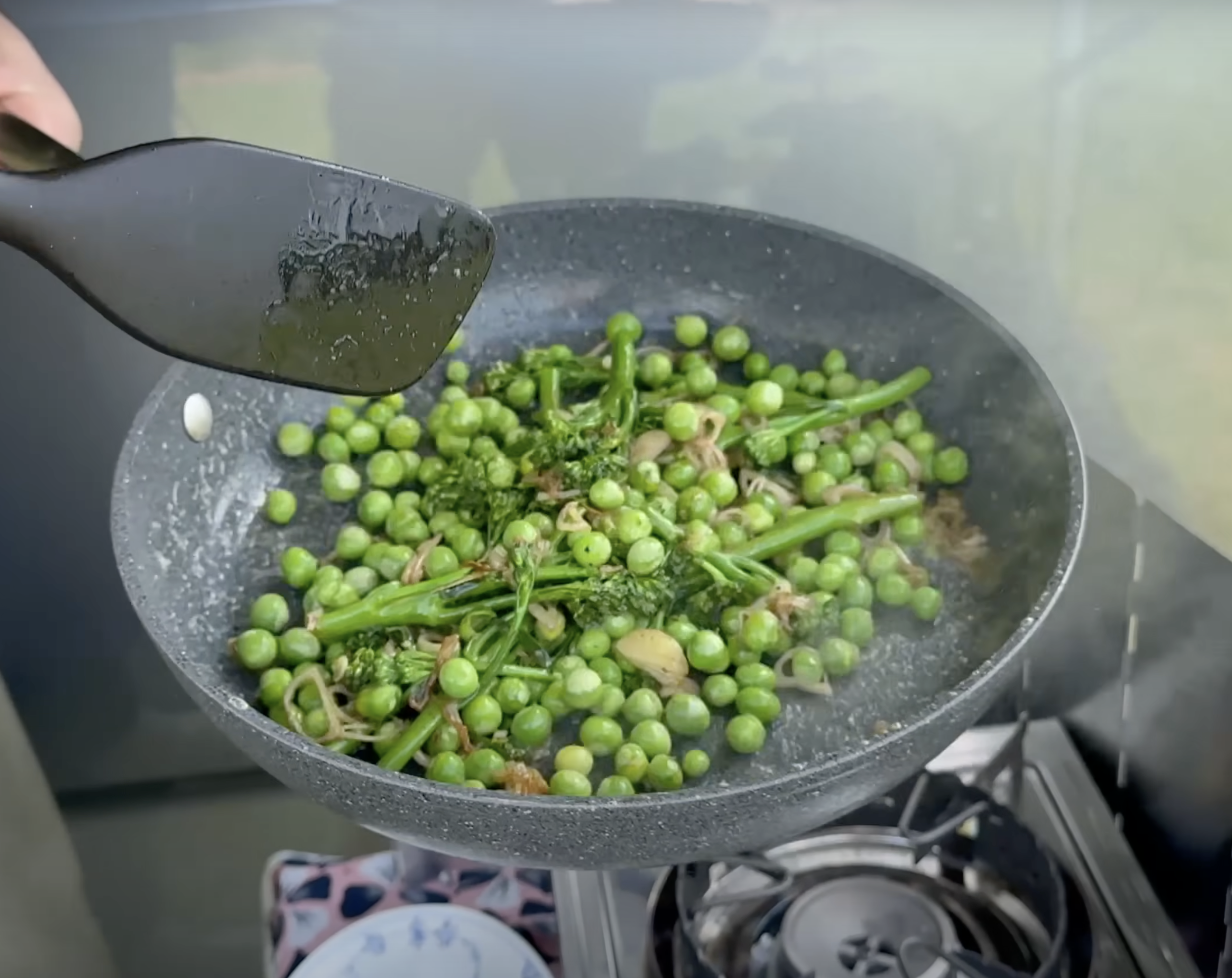 sauterede broccolini og ærter på en pande